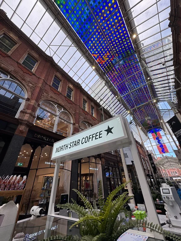 An image of the North Star Coffee post and panel sign in the interior of the mall.